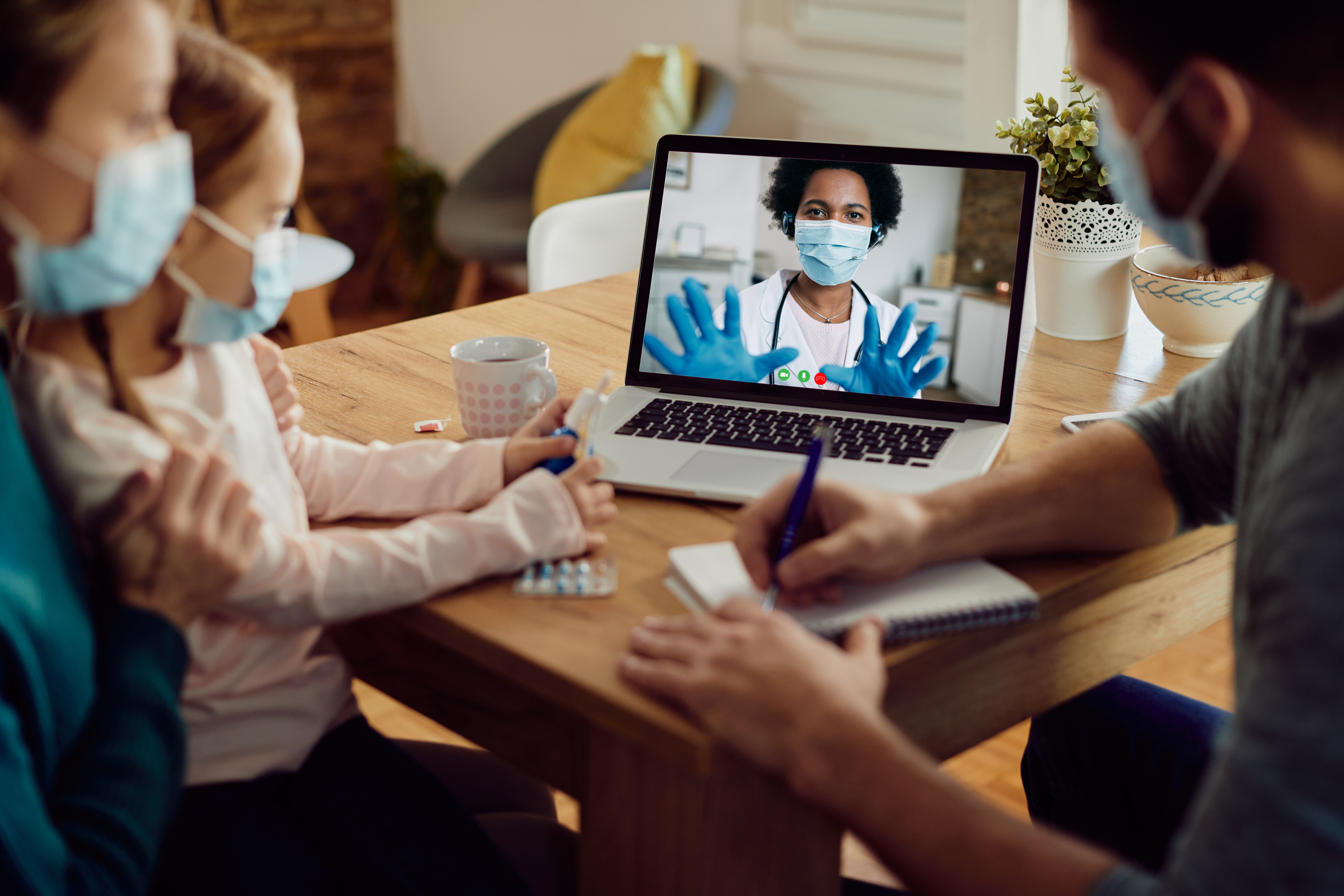Family consulting with a psychiatrist via video call at home